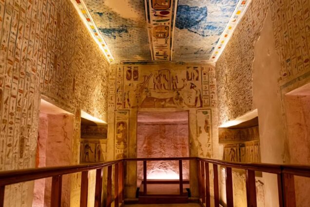 Interior view of the tomb of Ramesses IV (KV2) in the Valley of the Kings, featuring high ceilings with astronomical paintings, colorful hieroglyphics on the walls, and a wooden visitor walkway.